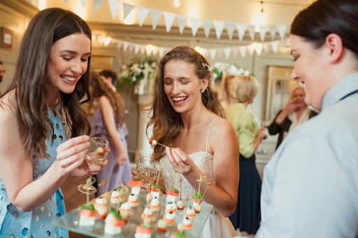 Image of two wedding guests trying some canapes